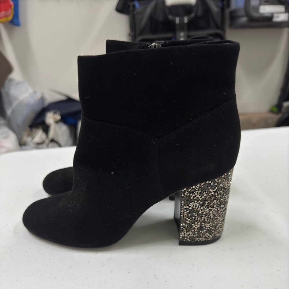 Black Michael Kors booties with glittered heel.